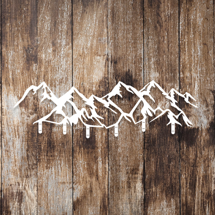 Rustic and contemporary mountain-shaped metal wall hanger.