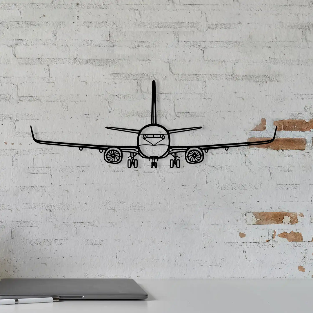 Black metal silhouette of a Boeing airplane viewed from the front.