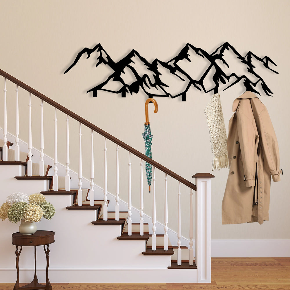 Stylish mountain silhouette metal wall rack for coats, hats, and keys.