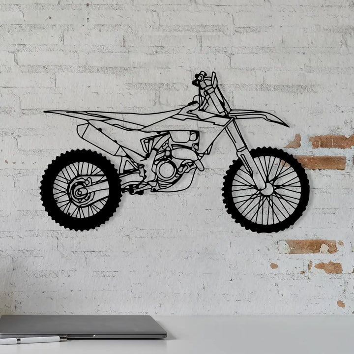 Black metal silhouette of a motocross motorcycle mounted on a living room wall.