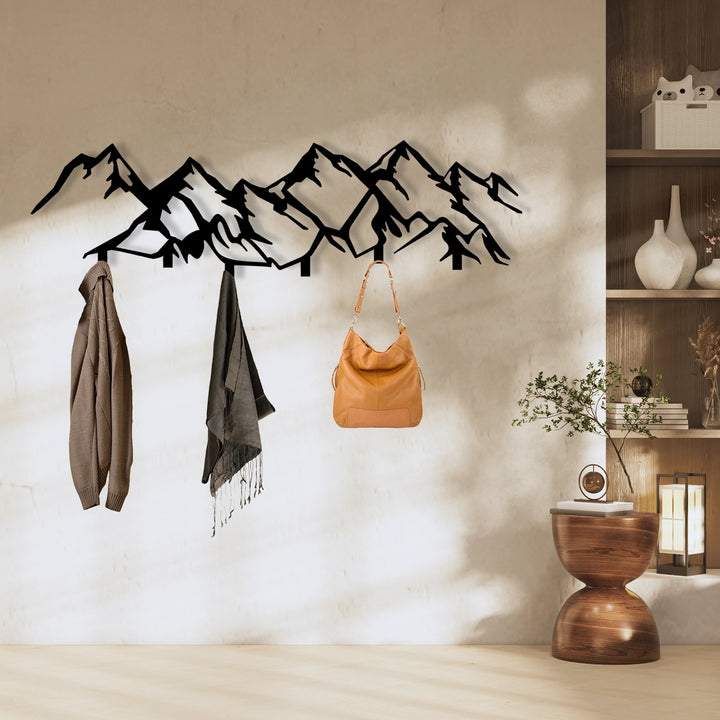 Minimalist black metal mountain wall hook for hallway organization.