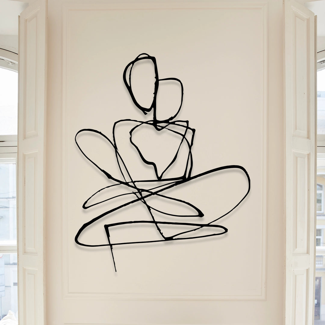 A wall-mounted metal wall art representing an abstract couple figure.